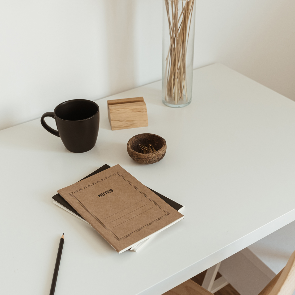 Notebooks, Pen, Cup and Vase on Table